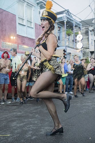 Ali Timberlake, of Tap Dat, performs outside of the Maple Leaf Bar before the parade begins. The Krewe of O.A.K. celebrated the 30th anniversary of Mid Summer Mardi Gras with the theme "Get Wet". (Zach Brien, UptownMessenger.com)