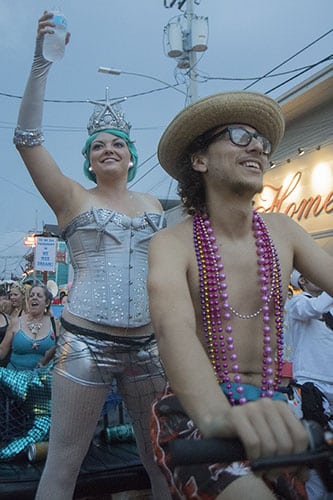 Cara-Mia Noto, the queen of O.A.K., waves to the crowd as she rolls down Oak street. The Krewe of O.A.K. celebrated the 30th anniversary of Mid Summer Mardi Gras with the theme "Get Wet". (Zach Brien, UptownMessenger.com)