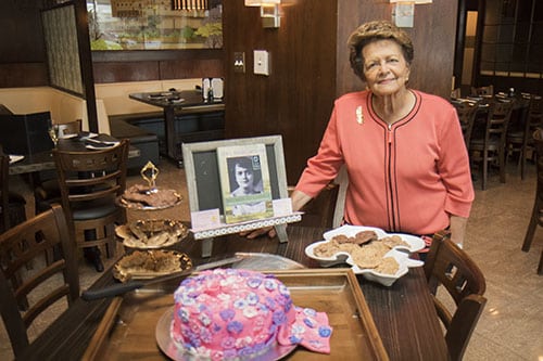 Sybil Morial poses with a copy of her book, Witness to Change. Morial read selections from her book and signed copies at Poseidon restaurant on Saint Charles avenue. (Zach Brien, UptownMessenger.com)