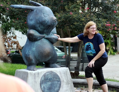A visitor to Terpsichore Street poses with the mysterious new Pikachu statue on Monday morning. (Robert Morris, UptownMessenger.com)