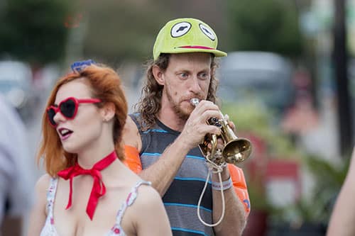 Dan Ruch of the Browncoat Brass warms up before Mid Summer Mardi Gras. The Krewe of O.A.K. celebrated the 30th anniversary of Mid Summer Mardi Gras with the theme "Get Wet". (Zach Brien, UptownMessenger.com)