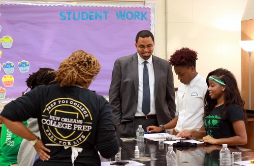 U.S. Secretary of Education John King discusses an experiment on soil samples with students Shamon Gurley and Jordyn Smith in Ariee Smith's AP Environmental Science class. (Robert Morris, UptownMessenger.com)
