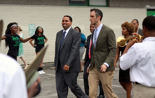 U.S. Secretary of Education John King is greeted by the band as he walks into Walter L. Cohen College Prep High School with principal Michael George. (Robert Morris, UptownMessenger.com)