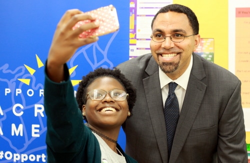 Cohen High School student Duat'e Martin poses for a selfie with U.S. Secretary of Education John King on Friday. (Robert Morris, UptownMessenger.com)