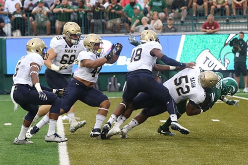 Navy defensive end Amos Mason drops Tulane running back Dontrell Hilliard during their first possession of the game. Navy defeated Tulane 21-14 at Yulman Stadium. (Zach Brien, UptownMessenger.com)