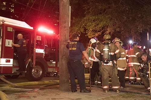 NOFD member gather outside 2119 Calhoun street after a fire was successfully contained. All of the residents were able to escape the residence without harm, but the building itself was substantially burned. (Zach Brien, UptownMessenger.com)