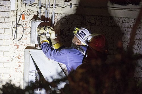 An NOFD member checks the meter outside of the burned house at 2119 Calhoun street after a fire broke out Monday night. All of the residents were able to escape the residence without harm, but the building itself was substantially burned. (Zach Brien, UptownMessenger.com)