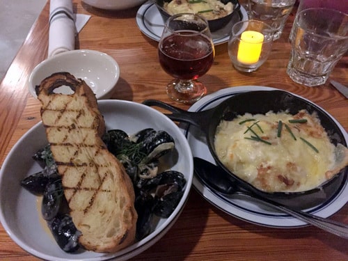 The steamed mussels on the small plate menu paired with Lagunitas Brown Shugga’ and a side of potato/ turnip gratin. (Photo by Dannielle Garcia)
